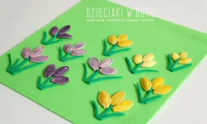 Wiosenne kwiaty z pestek dyni na zielonym filcu. Dzieciaki w domu tworzą piękne, kolorowe kompozycje.